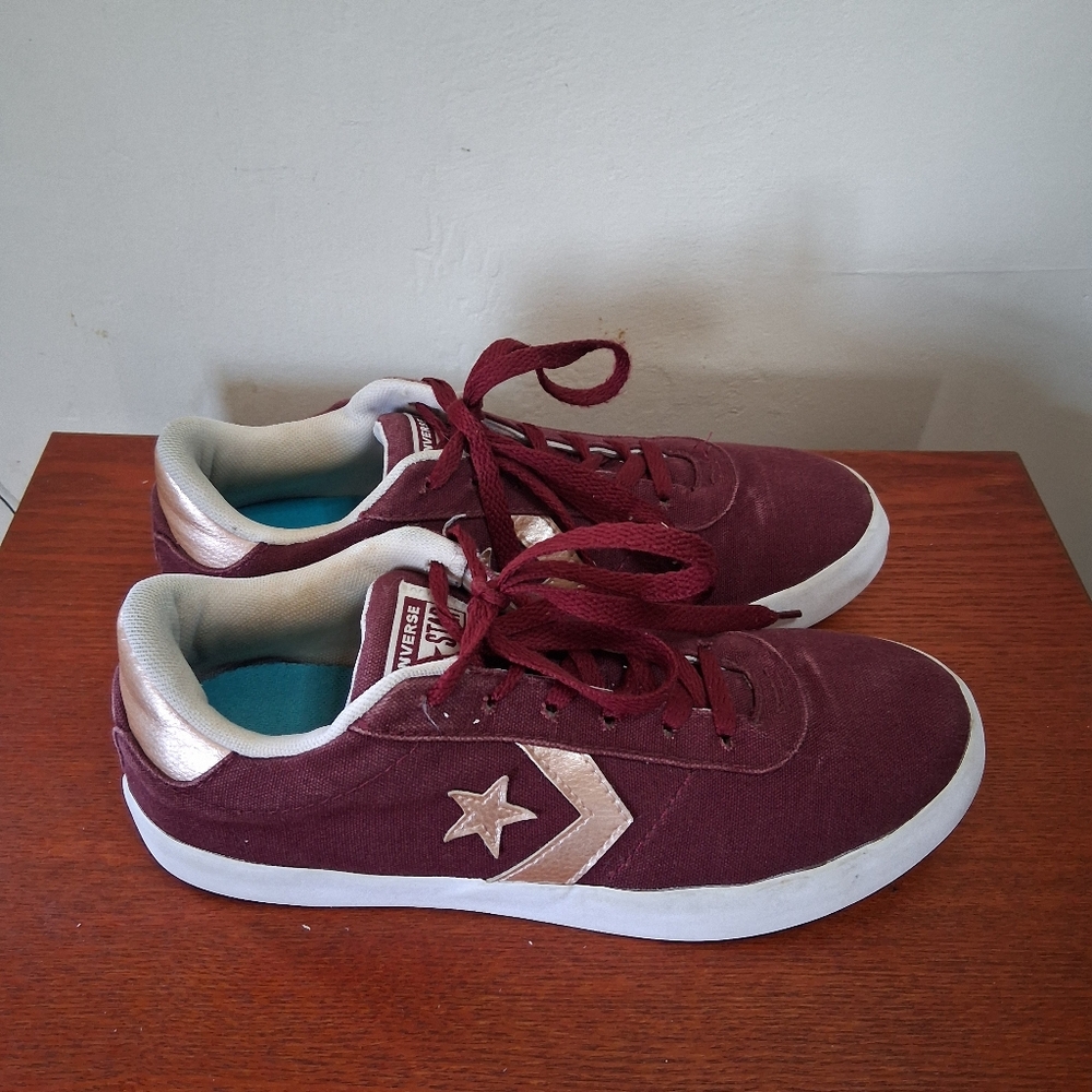 The Converse All Star Point Star Low Top Burgundy Sneakers with Gold Star Logo
